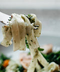 Pistachio pesto tossed with pasta, ready for a bite on the fork — Tutto Sicilia
