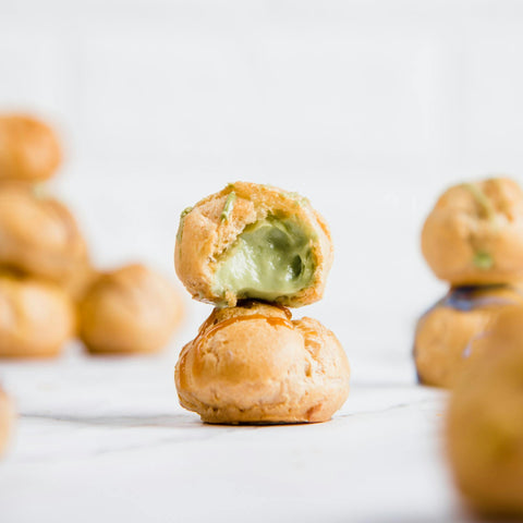 Pistachio cream filled cream puff piled on counter — Tutto Sicilia
