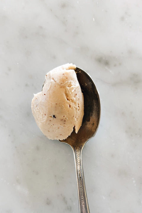 Spoonful of Sicilian almond cream made from Pizzuta d'Avola almonds on a marble surface